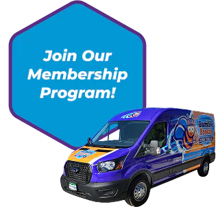 A colorful service van with a bee logo is parked in front of a blue hexagon sign that reads, "Join Our Membership Program!.