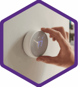 %Focuskw% | Bumble Breeze Plumbing, Heating &Amp; Air A hand adjusts a modern digital thermostat mounted on a wall, displaying the temperature set to 77 degrees.